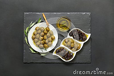 Three kinds of selected olives and olive oil. Stock Photo