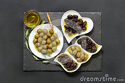 Three kinds of selected olives and olive oil. Stock Photo