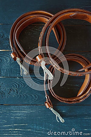 Three leather brown belts on dark background Stock Photo