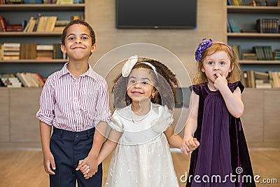 Three little children in celebratory clothes Stock Photo