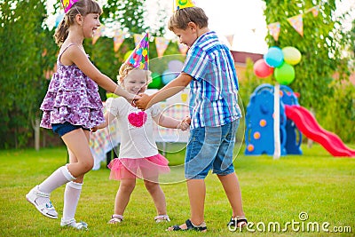 Three little kids dancing roundelay Stock Photo