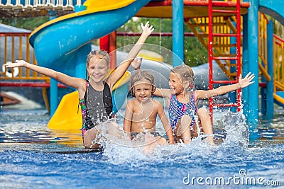 Three little kids playing in the swimming pool Stock Photo