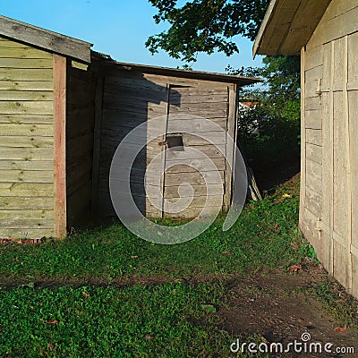 Three locked old wooden sheds Stock Photo