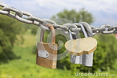 Three locks on a thick galvanized chain Stock Photo