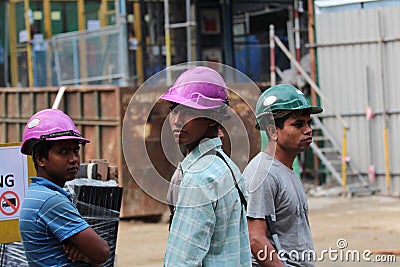 Three male construction workers at a construction site Editorial Stock Photo