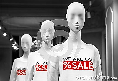 Three mannequins in a clothing store in the sales season Stock Photo