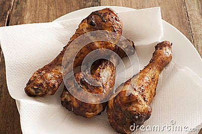 Three marinated spicy chicken drum sticks Stock Photo