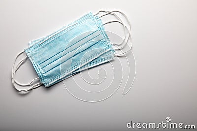 Three Medical Face Masks Resting on Gradated Surface Stock Photo