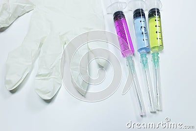 Three medical syringe with blue, green and red liquids. Close up Stock Photo