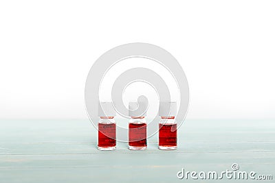 Three medicine vials filled with red liquid Stock Photo