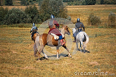 Three medieval armored knights on horses Stock Photo