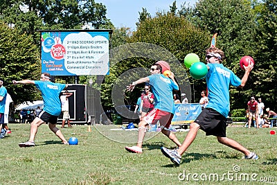 Three Men Throw In Unison At Outdoor Dodge Ball Game Editorial Stock Photo