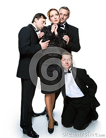 Three men in tuxedos and cheerful girl Stock Photo