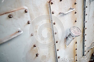 Three metal hatches plates on compressor for revision close-up with oil stains painted with gray paint bolted with studs Stock Photo