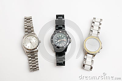 Three metal strapped watches of silver, white and black color Stock Photo