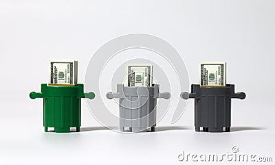 Three miniature trash cans and a hundred dollar bill. Stock Photo