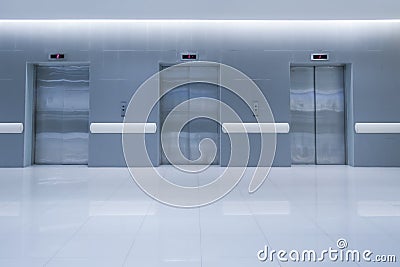 Three Modern passenger or cargo elevators in hotel or hospital and white floor Stock Photo