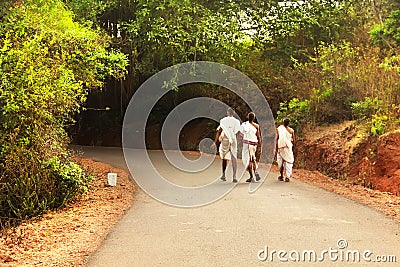 Three monks walking on the road. Gokarna, Karnataka, India Editorial Stock Photo