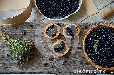 Three muffins and a big pie with blueberries Stock Photo