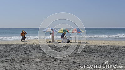 Three beach umbrellas, blue sky and ocean. Editorial Stock Photo