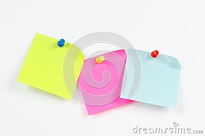 Three multi-colored stickers on white message board Stock Photo