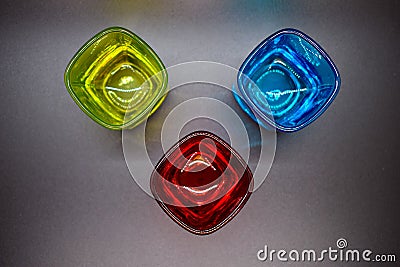 Three multicolored shot glasses on black background Stock Photo