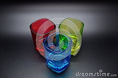 Three multicolored shot glasses on black background Stock Photo