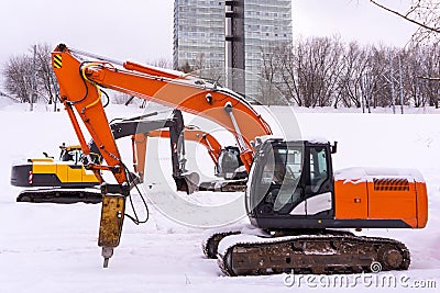 Dance of excavators in the snow Stock Photo