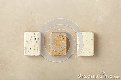 Three natural soap bars - lavender, cotton, patchouli - on natural stone background, flat lay Stock Photo
