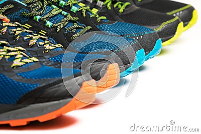 Three new pairs of colourful running shoes / exercise trainers Stock Photo