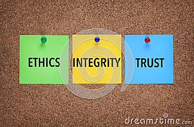 Three notes on corkboard with words Integrity, Trust, Ethics. Stock Photo