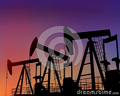 Three oil wells in the desert at dusk Stock Photo