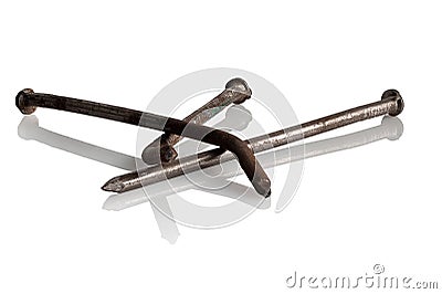 Three old, rusty, bent nails Stock Photo