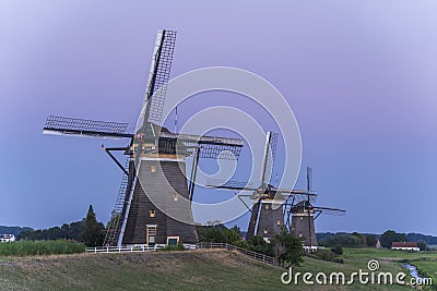 Three old windmills from the year 1672 in Stompwijk Molendriegang Stompwijk, the Netherlands just after sunset Stock Photo