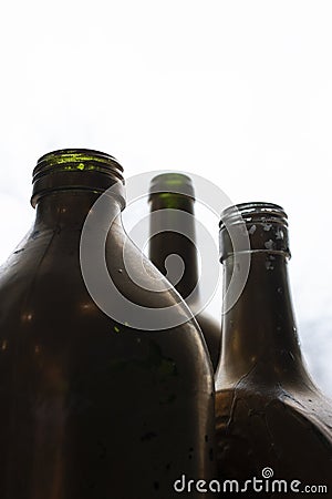 Three open dark glass bottles Stock Photo