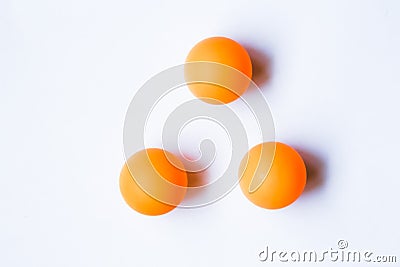Three orange ping pong balls on white background. Stock Photo
