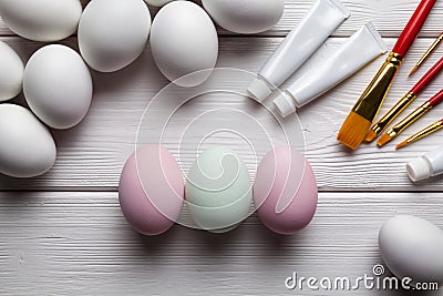 Three painted Easter eggs and many white eggs Stock Photo