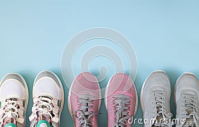 Three pair of sport shoes top view on light blue background Stock Photo
