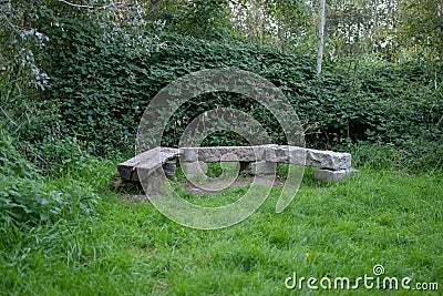 Three-part stone bench in a green park Stock Photo