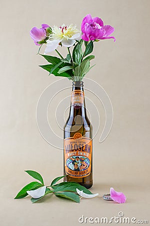 Three peonies in an IPA beer bottle Editorial Stock Photo