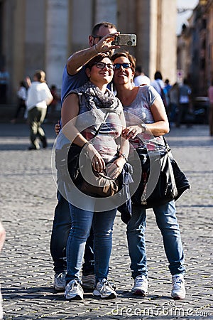 Three people doing selfie with smartphone Editorial Stock Photo