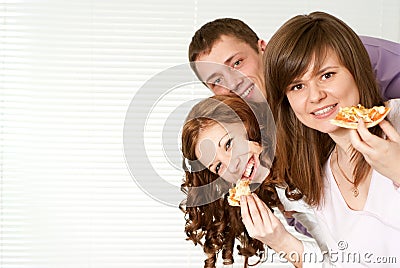 Three people eating pizza Stock Photo