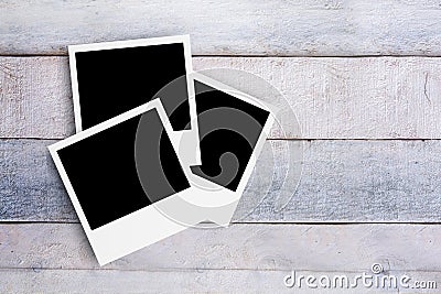Three photo frames on a white wooden desktop. Top down view and mock up for photo gallery. Empty copy space Stock Photo
