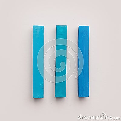 Three pieces of blue pastel crayon chalks Stock Photo