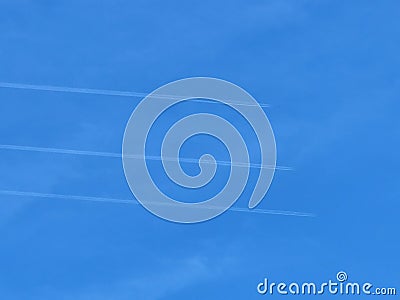 Three planes side by side with exhaust contrails against blue sky Stock Photo