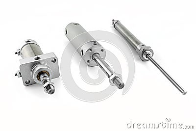 Three pneumatic air cylinders with thread and nut at the end, visible screw-in air dampers, isolated on a white background. Stock Photo