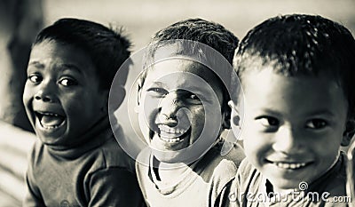 Three poor kids smiling together Editorial Stock Photo