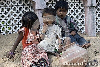 Three poor slum children playing on sand Editorial Stock Photo