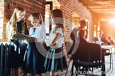 Three positive girl discussing the news Stock Photo