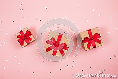 Three presents with red bow on pink Stock Photo